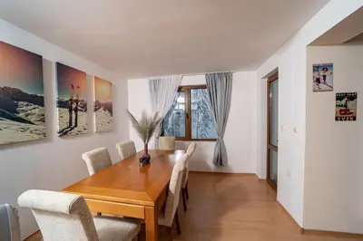 a dining room with a wooden table and chairs at CrosswayBg Pamporovo in Pamporovo