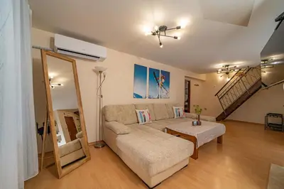 a living room with a couch and a table at CrosswayBg Pamporovo in Pamporovo