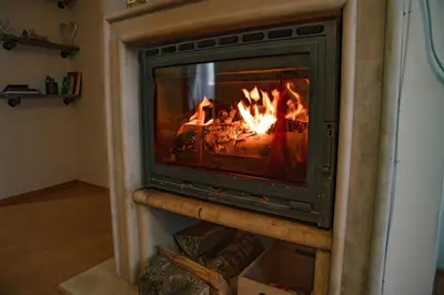 a fireplace with a fire in it at CrosswayBg Pamporovo in Pamporovo
