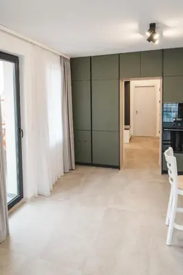 a living room with green walls and a table and chairs at Apartment Aria 3 in Velingrad