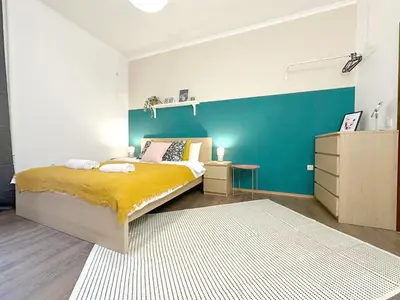 a bedroom with a bed and a blue wall at Aurora Abode - Top Center 1 BDR Fast Wi-fi in Sofia