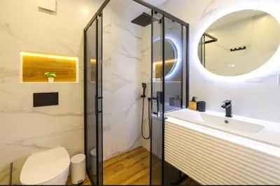 a bathroom with a shower and a toilet and a sink at Designer apartment at Pirin Sense in Bansko