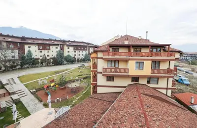 a building with a balcony on top of it at Designer apartment at Pirin Sense in Bansko