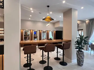 a kitchen with a bar with stools and mirrors at Designer apartment at Pirin Sense in Bansko