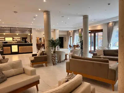 a living room with couches and chairs in a lobby at Designer apartment at Pirin Sense in Bansko