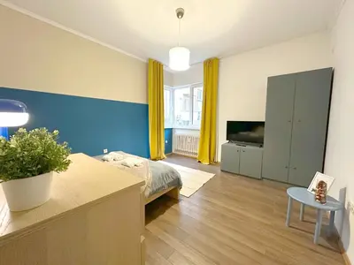 a bedroom with a bed and a tv in it at Echoes of Comfort - Top Center 1 BDR Fast Wi-fi in Sofia