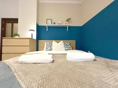 a blue bedroom with a bed with two white pillows at Echoes of Comfort - Top Center 1 BDR Fast Wi-fi in Sofia