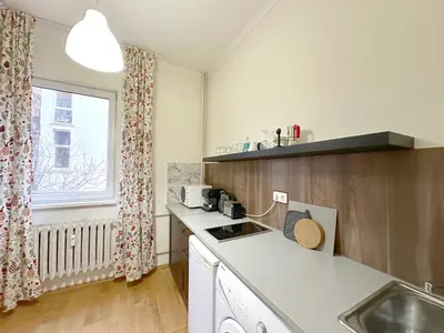 a small kitchen with a sink and a window at Echoes of Comfort - Top Center 1 BDR Fast Wi-fi in Sofia