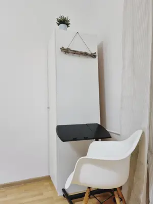 a white chair and a desk in a room at Apartment for four next to blvd Vitosha in Sofia