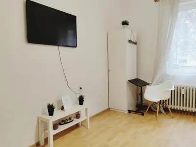 a living room with a flat screen tv on a wall at Apartment for four next to blvd Vitosha in Sofia