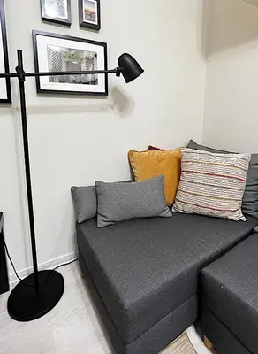 a living room with a couch with a lamp at Great location in the Center in Sofia