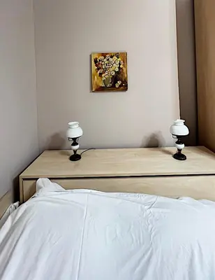 a bedroom with a bed with two lamps on it at Great location in the Center in Sofia