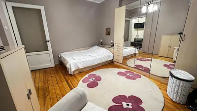 a bedroom with two beds and a large mirror at Great location in the Center in Sofia