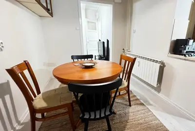a dining room with a wooden table and chairs at Great location in the Center in Sofia