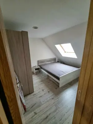 a bedroom with a bed and a window on the ceiling at Fast Wi-Fi, Kitchen, In Sofia in Sofia