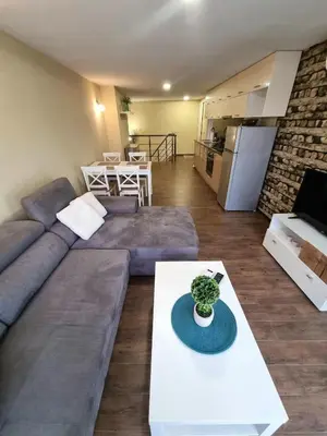 a living room with a couch and a table at Fast Wi-Fi, Kitchen, In Sofia in Sofia