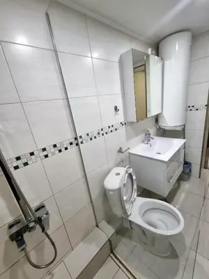 a white bathroom with a toilet and a sink at Fast Wi-Fi, Kitchen, In Sofia in Sofia