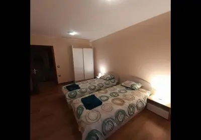 a bedroom with a bed with two pillows on it at GONDOLA APARTMENTS BANSKO - SUVOROV VIP Complex in Bansko