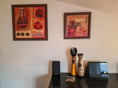 a table with a laptop and pictures on the wall at Glazne River View - 2BDR & 2BTHR Flat with a View by Flat Mаnager in Bansko