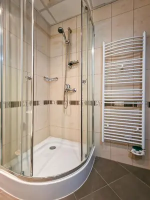 a shower with a glass door in a bathroom at Glazne River View - 2BDR & 2BTHR Flat with a View by Flat Mаnager in Bansko