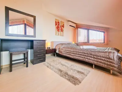 a bedroom with a bed and a desk and a mirror at Glazne River View - 2BDR & 2BTHR Flat with a View by Flat Mаnager in Bansko