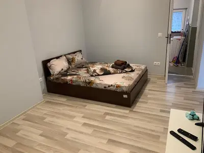 a dog laying on a bed in a room at Southern Hill in Sofia