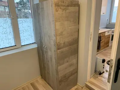 a sliding barn door in a kitchen next to two windows at Southern Hill in Sofia