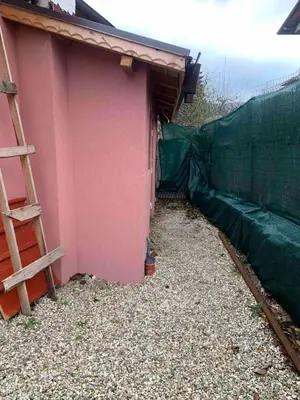 a pink house with a fence and a ladder at Southern Hill in Sofia