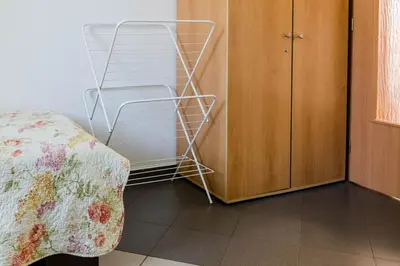 a bedroom with a bed next to a wooden cabinet at Best Location in Sofia Center in Sofia