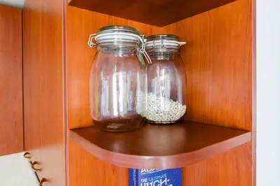 two glass jars sitting on a shelf in a cabinet at Best Location in Sofia Center in Sofia