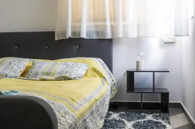 a bedroom with a bed and a side table at Best Location in Sofia Center in Sofia