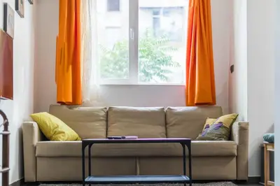 a living room with a couch and a window at Best Location in Sofia Center in Sofia