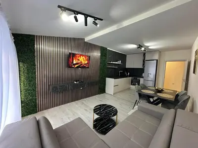 a living room with a couch and a dining room at Nikos Apatament in Velingrad