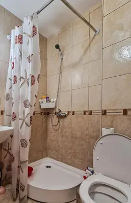 a small bathroom with a toilet and a shower at Mountain View Studio, Steps from Bansko Gondola by Flat Mаnager in Bansko