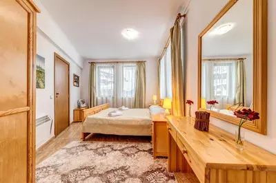 a bedroom with a bed and a large mirror at Alpine Haven 2-Bedroom Escape, Pamporovo by Flat Mаnager in Pamporovo