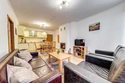 a living room with two couches and a table at Alpine Haven 2-Bedroom Escape, Pamporovo by Flat Mаnager in Pamporovo