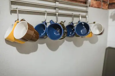 a bunch of pots and pans hanging on a rack at Cozy Luxurious Apartment Next to Borovets and Rila mountain in Govedartsi
