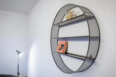 a circular mirror hanging on a wall at Cozy Luxurious Apartment Next to Borovets and Rila mountain in Govedartsi