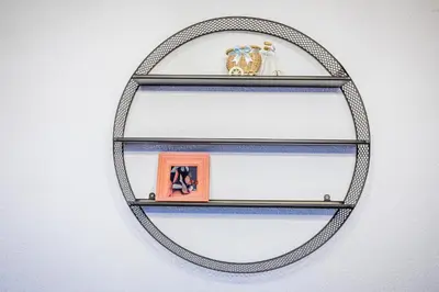 a metal shelf with some figurines on it at Cozy Luxurious Apartment Next to Borovets and Rila mountain in Govedartsi
