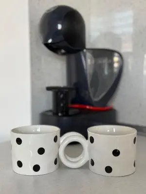 two polka dot coffee mugs sitting on a counter at La Mont Apartment Bansko in Bansko