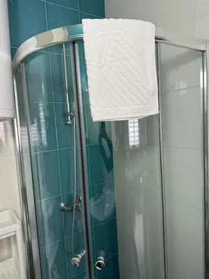 a towel is hanging on the side of a shower at La Mont Apartment Bansko in Bansko