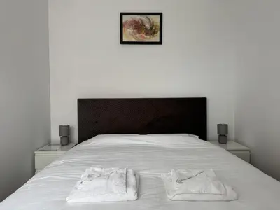 a bed with two towels sitting on top of it at La Mont Apartment Bansko in Bansko