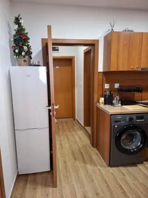a kitchen with a refrigerator and a washing machine at Двуспален апартамент Милена в хотел Росица,Пампорово in Pamporovo