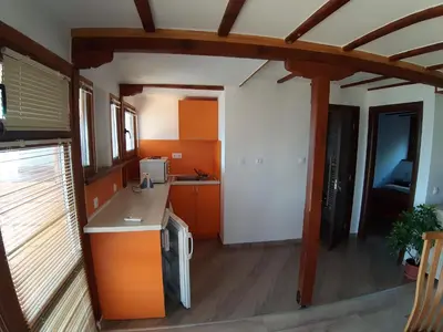 a kitchen with orange cabinets and a counter top at Tora Bora Guest House in Pancharevo