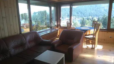 a living room with a couch and chairs and a table at Tora Bora Guest House in Pancharevo