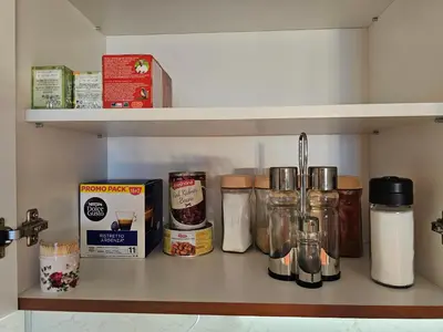 a shelf with jars and other items on it at Viva 4-A-23 Apartment ski to the door complex Grand Monastery Pamporovo in Pamporovo