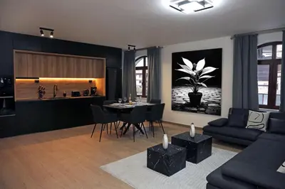 a living room with a couch and a dining room at Luxury Apartment 5 Mins from Slopes Parking in Bansko