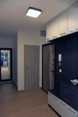 a room with a kitchen with a door and a hallway at Luxury Apartment 5 Mins from Slopes Parking in Bansko