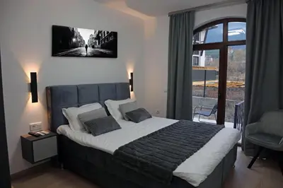a bedroom with a large bed and a window at Luxury Apartment 5 Mins from Slopes Parking in Bansko