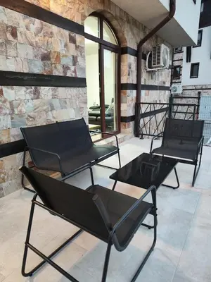a group of black chairs sitting on a patio at Luxury Apartment 5 Mins from Slopes Parking in Bansko